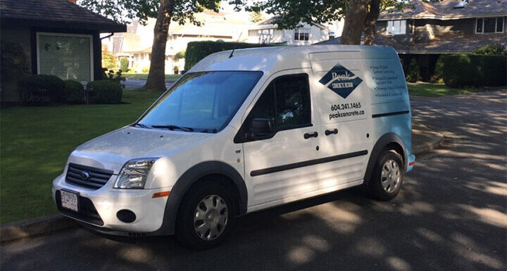 A white van with the Peak Concrete logo on a residential street